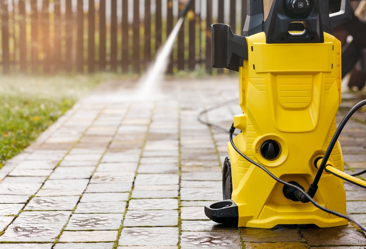 Pressure cleaning pavement with a high-pressure washer on a Los Angeles street